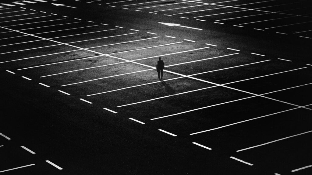 Image of a person walking alone in a parking lot. 
Credit: Harut Movsisyan 