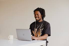 black man on laptop for Basic Computer Program page. Image credit: Unsplash