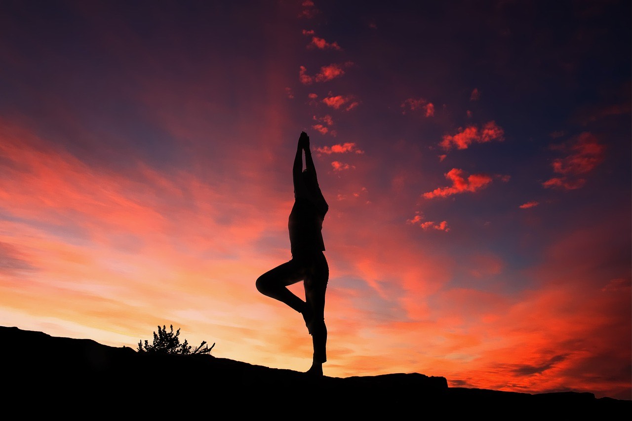 Image of a person silhouette while doing a simple standing yoga exercise during a sunset. image by TheDigitalArtist Pete Linforth
